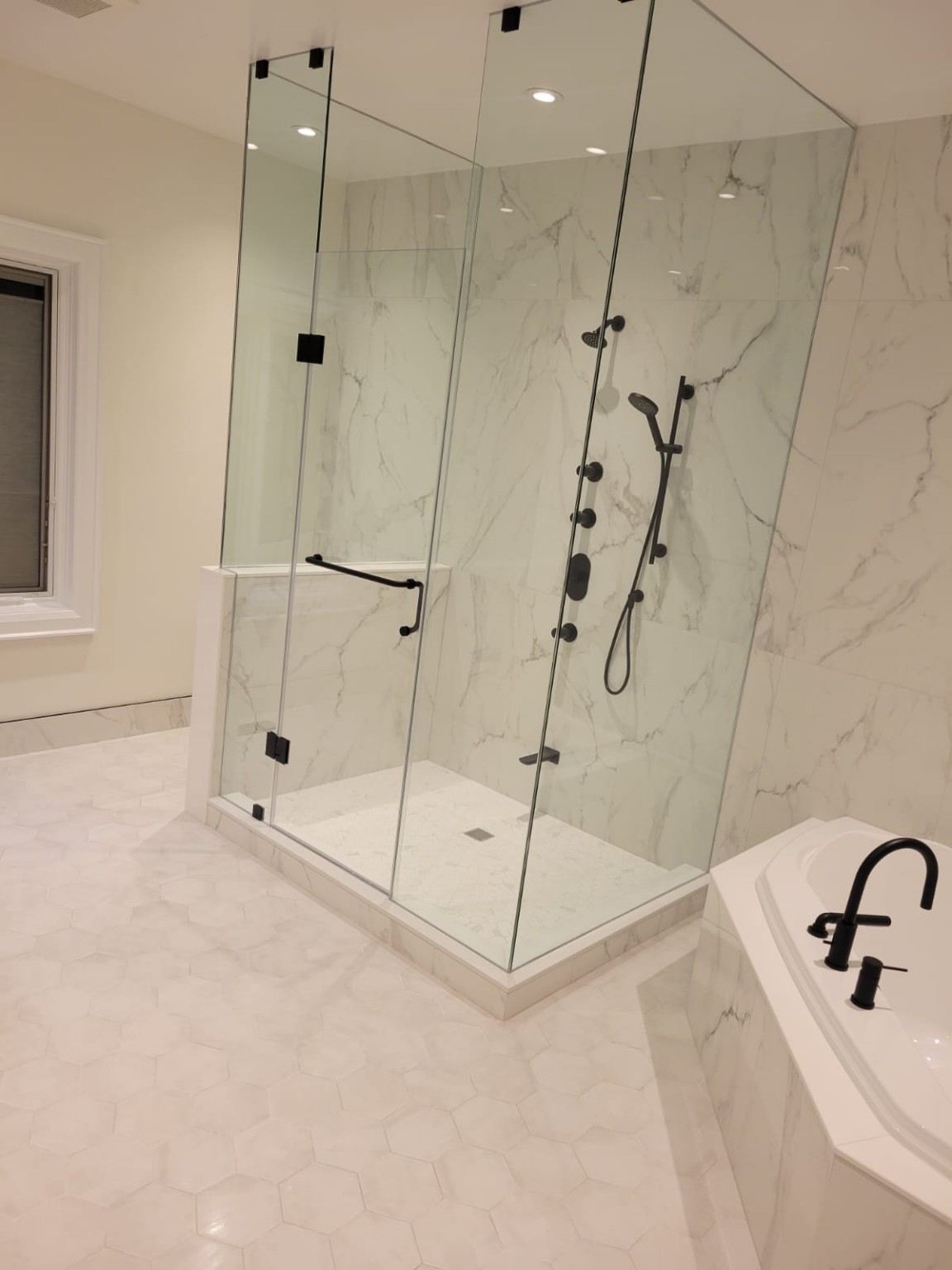 Clean glass shower and polished fixtures