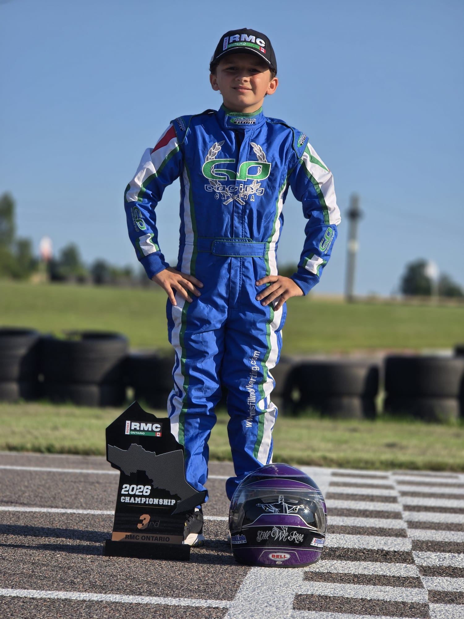 Angelo Launi with his RMC Ontario championship trophy and racing helmet